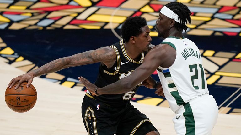 Atlanta Hawks&#39; Lou Williams (6) keeps the ball away from Milwaukee Bucks&#39; Jrue Holiday (21) during the first half of Game 4 of the NBA basketball Eastern Conference finals Tuesday, June 29, 2021, in Atlanta.