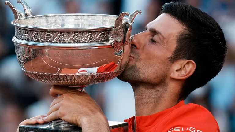 Serbia's Novak Djokovic kisses the cup after defeating Stefanos Tsitsipas of Greece in their final match of the French Open tennis tournament at the Roland Garros stadium Sunday, June 13, 2021 in Paris. Djokovic won 6-7, 2-6, 6-3, 6-2, 6-4. (AP Photo/Thibault Camus)