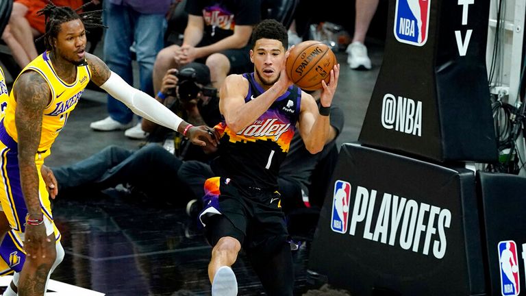 Phoenix Suns guard Devin Booker (1) passes against the Los Angeles Lakers during the first half of Game 5 of an NBA basketball first-round playoff series, Tuesday, June 1, 2021, in Phoenix. (AP Photo/Matt York)