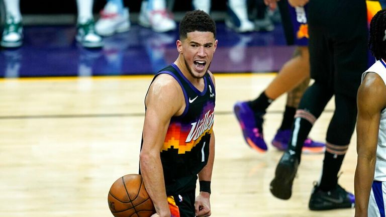 Phoenix Suns guard Devin Booker shouts in celebration in the closing seconds during the second half of Game 1 of the NBA basketball Western Conference finals against the Los Angeles Clippers, Sunday, June 20, 2021, in Phoenix. The Suns defeated the Clippers 120-114. (AP Photo/Ross D. Franklin)