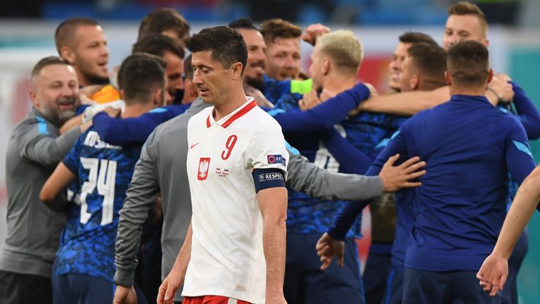 Slovakia celebrate at full-time as Poland captain Robert Lewandowski leaves the field