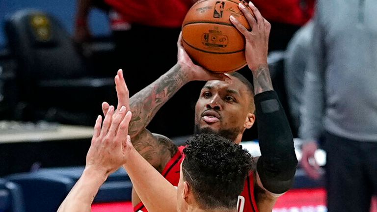 Portland Trail Blazers guard Damian Lillard (0) shoots a 3-point basket at the buzzer against Denver Nuggets forward Michael Porter Jr. (1) to send Game 5 of a first-round NBA basketball playoff series into overtime Tuesday, June 1, 2021, in Denver. (AP Photo/Jack Dempsey)