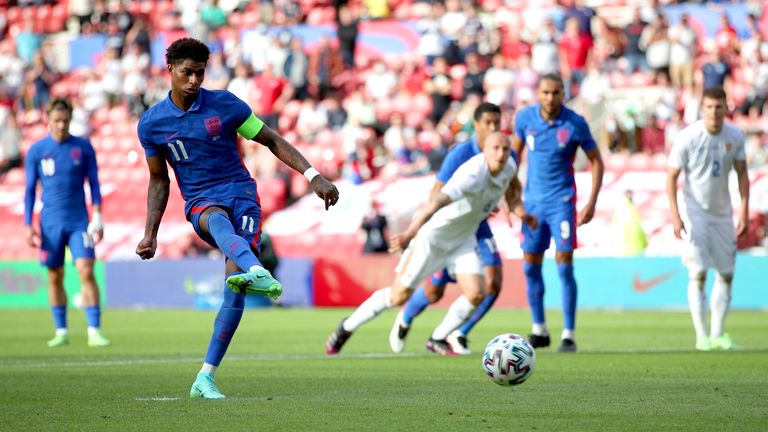 Marcus Rashford scores a penalty against Romania