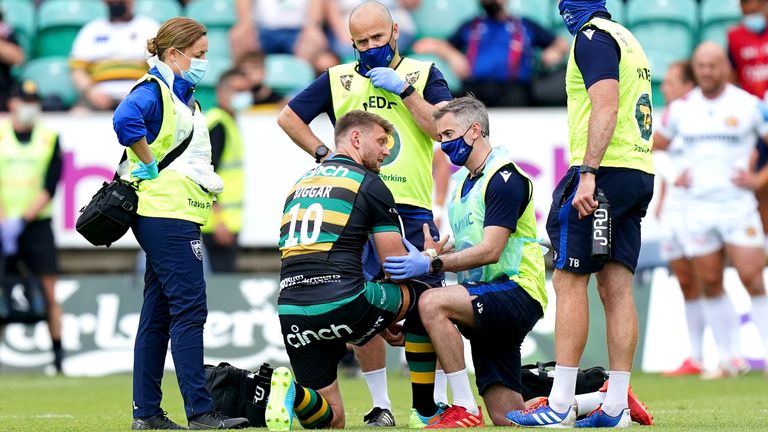 Northampton Saints' Dan Biggar receives medical attention before leaving the pitch with an injury