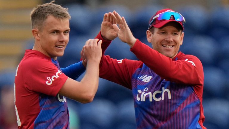 England&#39;s Eoin Morgan , centre congratulates his bowler Sam Curran, on taking the wicket of Sri Lanka&#39;s Avishka Fernando, during the T20 international cricket match between England and Sri Lanka at Cardiff, Wales, Wednesday, June 23, 2021. (AP Photo/Alastair Grant)