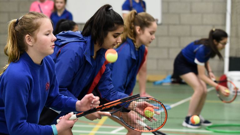 School girls practise their racket skills 