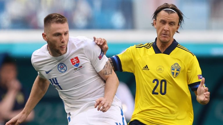 Slovakia's Milan Skriniar makes a pass while under pressure from Sweden's Kristoffer Olsson