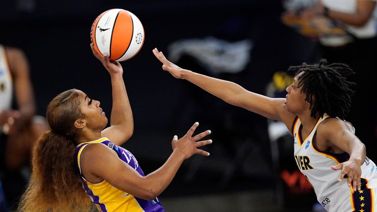 Los Angeles Sparks guard Te&#39;a Cooper shoots as Indiana Fever guard Kelsey Mitchell defends during the second half of a WNBA basketball game