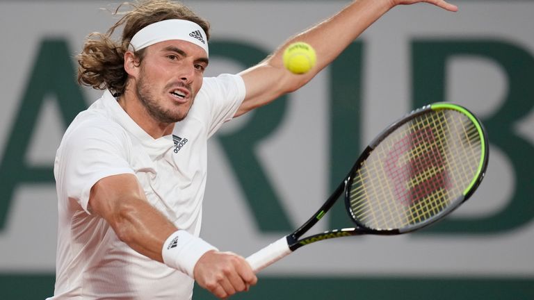 Stefanos Tsitsipas of Greece plays a return to United States' John Isner during their third round match on day 6, of the French Open tennis tournament at Roland Garros in Paris, France, Friday, June 4, 2021. (AP Photo/Christophe Ena)