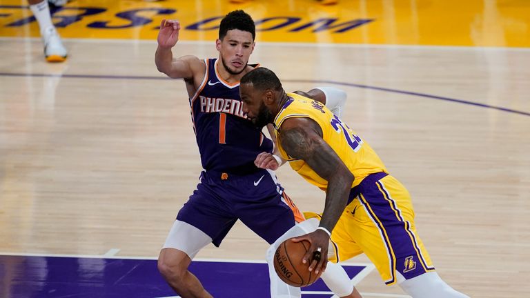 Phoenix Suns guard Devin Booker defends against Los Angeles Lakers forward LeBron James during Game 6 of an NBA basketball first-round playoff series