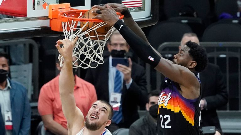 Phoenix Suns center Deandre Ayton, right, scores over Los Angeles Clippers center Ivica Zubac during the second half of Game 2 of the NBA basketball Western Conference Finals, Tuesday, June 22, 2021, in Phoenix.