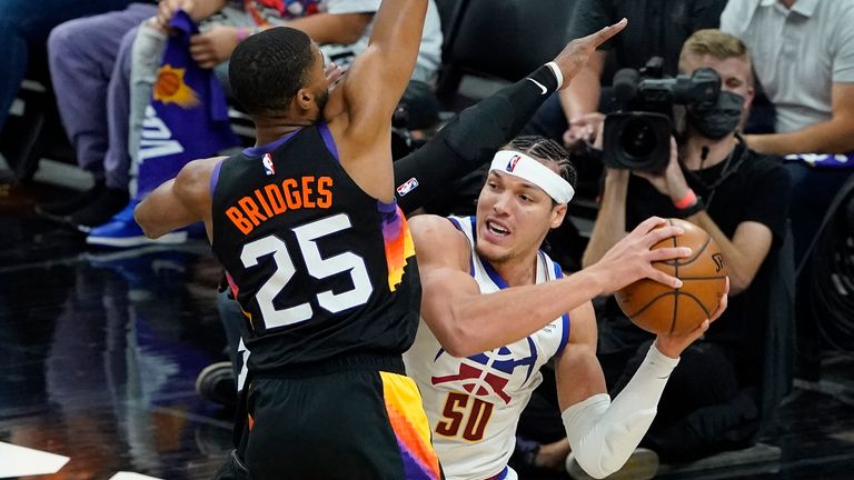 Phoenix Suns forward Mikal Bridges pressures Denver Nuggets forward Aaron Gordon during the second half of Game 2 of an NBA basketball second-round playoff series