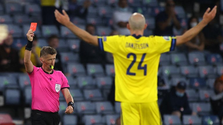 Referee Daniele Orsato shows a red card to Sweden's defender Marcus Danielsson