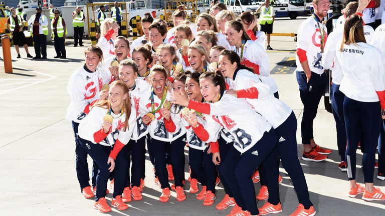 Team GB's women's hockey squad pose with their gold medals after arriving home from the Rio 2016 Games