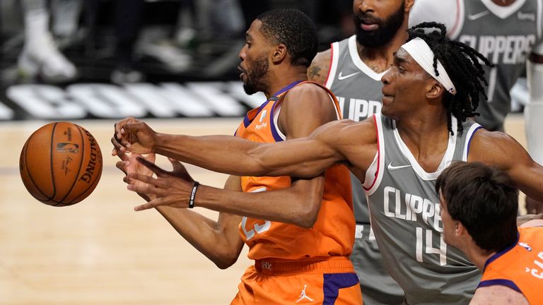 Los Angeles Clippers guard Terance Mann, right, knocks the ball from the hands of Phoenix Suns forward Mikal Bridges during the first half in Game 4 of the NBA basketball Western Conference Finals Saturday, June 26, 2021, in Los Angeles. 