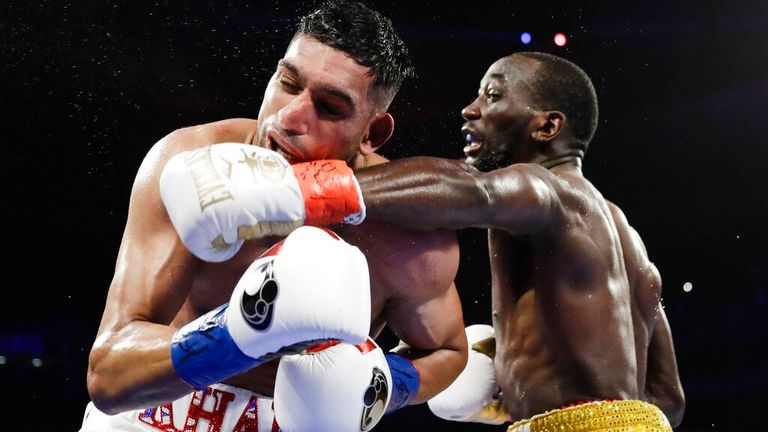 Terence Crawford, right, punches England...s Amir Khan during the fifth round of a WBO world welterweight championship boxing match Sunday, April 21, 2019, in New York. Crawford won the fight. (AP Photo/Frank Franklin II)