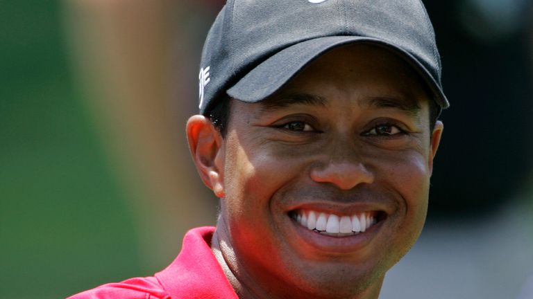 Tiger Woods smiles as he rides with his wife Elin Nordegren to the trophy presentation following his sudden death hole US Open championship victory following an 18-hole playoff round at Torrey Pines Golf Course on Monday, June 16, 2008 in San Diego.  (AP Photo/Lenny Ignelzi)