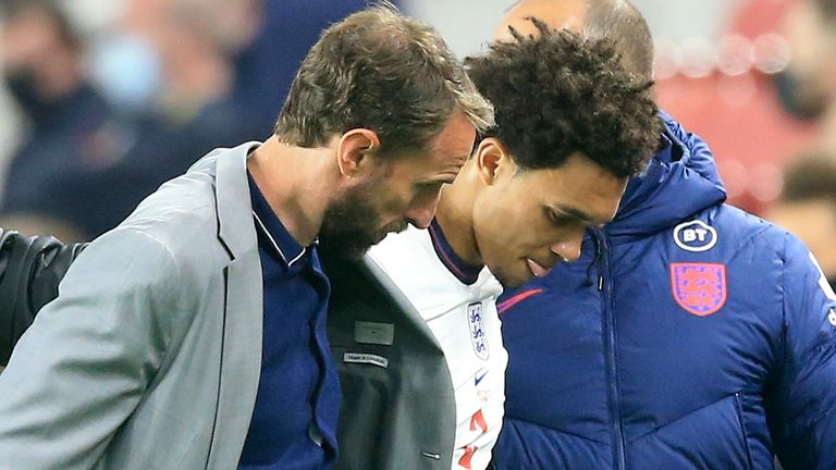 England coach Gareth Southgate assists England&#39;s Trent Alexander-Arnold after he came off the pitch injured during the friendly match with Austria.