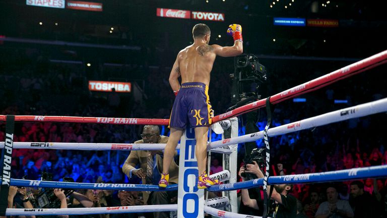 Boxer Vasiliy Lomachenko celebrates after nearly knocking out Anthony Crolla during their WBA/WBO lightweight title bout in Los Angeles Friday, April 12, 2019. (AP Photo/Damian Dovarganes)