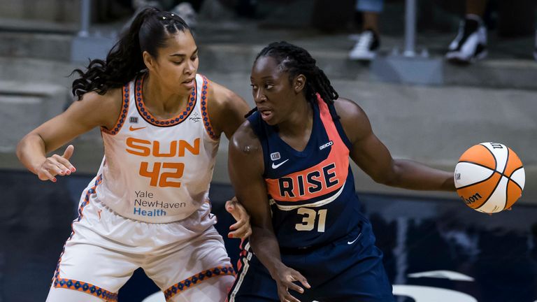  JUNE 30: Tina Charles #31 of the Washington Mystics handles the ball in front of Brionna Jones #42 of the Connecticut Sun during the first half of the game at Entertainment & Sports Arena on June 30, 2021 in Washington, 