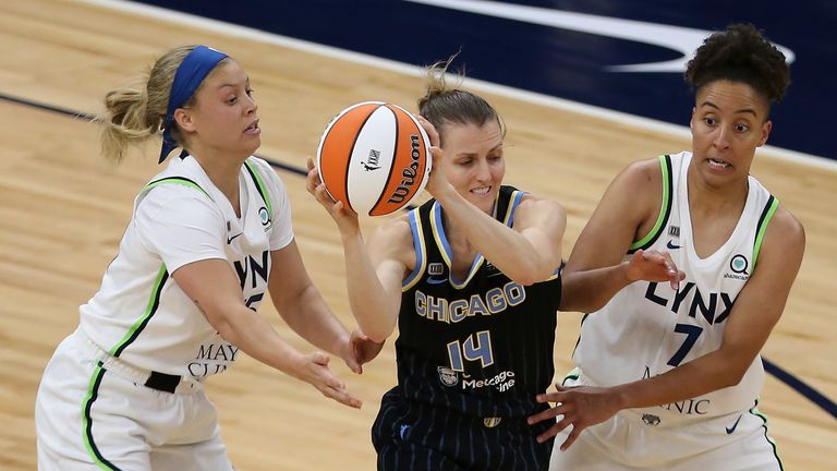 Chicago Sky's Allie Quigley (14) works between Minnesota Lynx's Rachel Banham (15) and Layshia Clarendon (7) during the second half of a WNBA basketball game Tuesday, June 15, 2021, in Minneapolis. Chicago won 105-89.