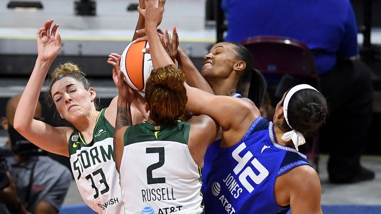 Connecticut Sun forward DeWanna Bonner, back, and center Brionna Jones (42) battle Seattle Storm forward Katie Lou Samuelson (33) and center Mercedes Russell (2) for the rebound during a WNBA basketball game Sunday, June 13, 2021 at Mohegan Sun Arena in Uncasville, Conn.