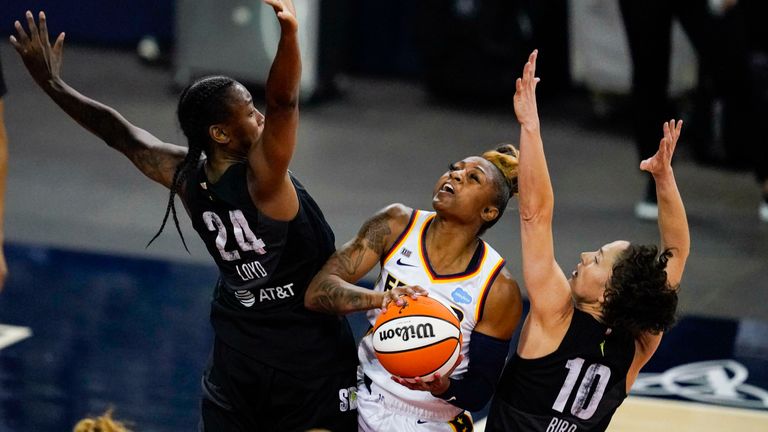 Indiana Fever guard Tiffany Mitchell shoots between Seattle Storm guard Jewell Loyd, left, and guard Sue Bird in the first half of an WNBA basketball game in Indianapolis, Tuesday, June 15, 2021.