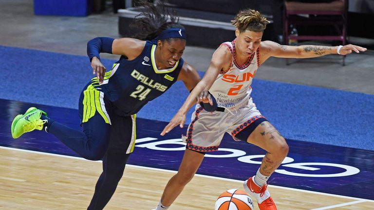 Dallas Wings guard Arike Ogunbowale deflects the ball away from Connecticut Sun guard Natisha Hiedeman during a WNBA basketball game Tuesday, June 22, 2021 at Mohegan Sun Arena in Uncasville, Conn. 