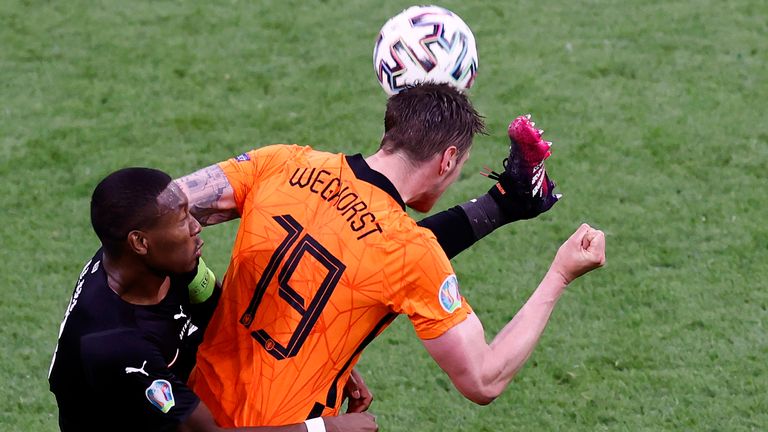 Wout Weghorst of the Netherlands, right, challenges for the ball with Austria's David Alaba during the Euro 2020 soccer championship group C match between Netherland and Austria, at Johan Cruyff Arena in Amsterdam, Thursday, June 17, 2021. (Koen van Weel, Pool via AP)