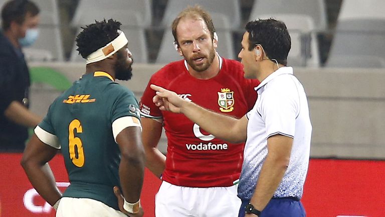 Referee Ben O'Keefe speaks with South Africa's Siya Kolisi and British & Irish Lions' Alun Wyn Jones 