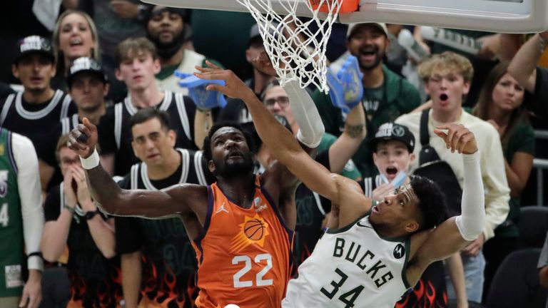 Milwaukee Bucks forward Giannis Antetokounmpo blocks a shot by Phoenix Suns center Deandre Ayton
