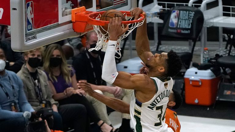 Milwaukee Bucks forward Giannis Antetokounmpo dunks the ball over Phoenix Suns forward Cameron Johnson during Game 4 of basketball&#39;s NBA Finals