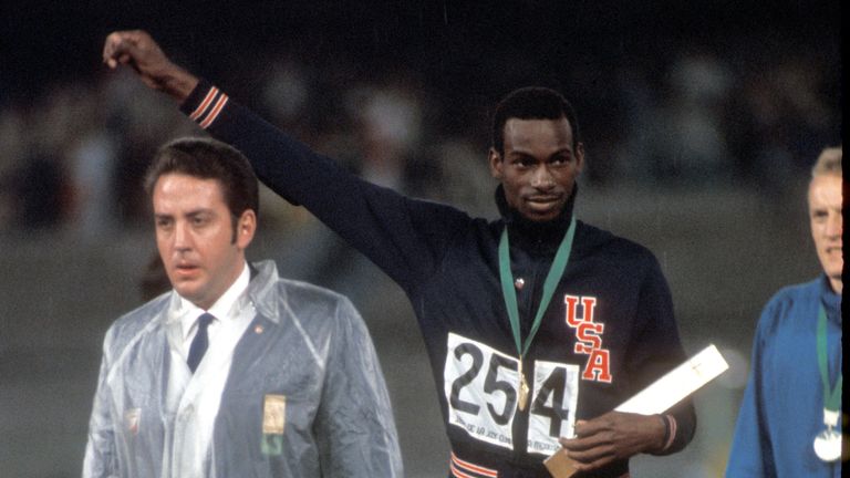 Beamon waves after receiving his gold medal on October 18 in Mexico City