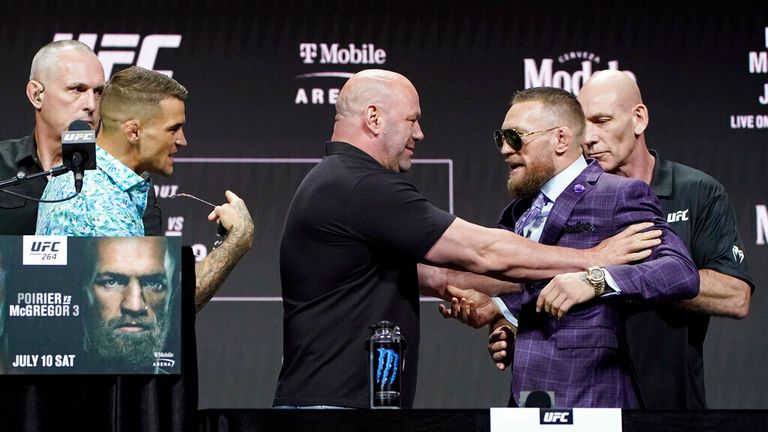 Dana White, center, UFC President, holds Conor McGregor away from Dustin Poirier during a news conference for a UFC 264 mixed martial arts bout Thursday, July 8, 2021, in Las Vegas. (AP Photo/John Locher)