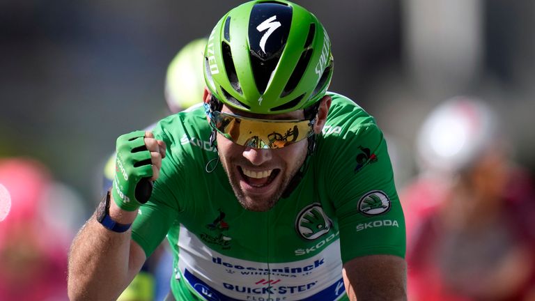 Britain's Mark Cavendish, wearing the best sprinter's green jersey, celebrates as he crosses the finish line to win the thirteenth stage of the Tour de France 