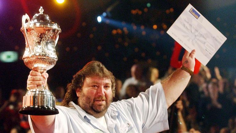 England's Andy Fordham shows his emotions as he celebrates with the winners cheque and trophy after winning the Final of the Lakeside World Professional Darts Championships against England's Mervyn King at the Lakeside Country Club in Frimley Green. Fordham defeated King 6-3 to win the Championship.
