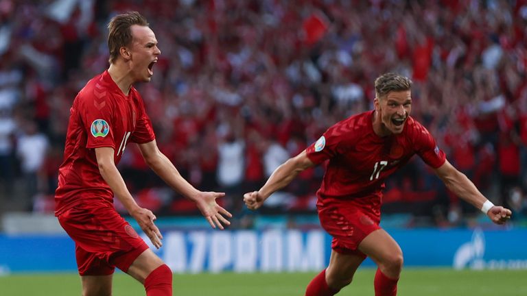 Denmark's Mikkel Damsgaard, left, celebrates with Jens Stryger Larsen after scoring his side's opening goal during the Euro 2020 soccer championship semifinal match between England and Denmark at Wembley 