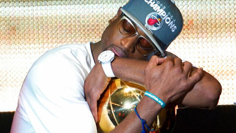 Miami Heat's Dwyane Wade hugs the NBA Championship trophy after the June 25, 2012 public celebration. (AP Photo/J Pat Carter)