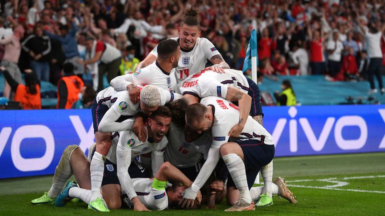 England's Harry Kane, bottom, celebrates with his teammates after scoring his side's second goal during the Euro 2020 soccer semifinal match between England and Denmark at Wembley