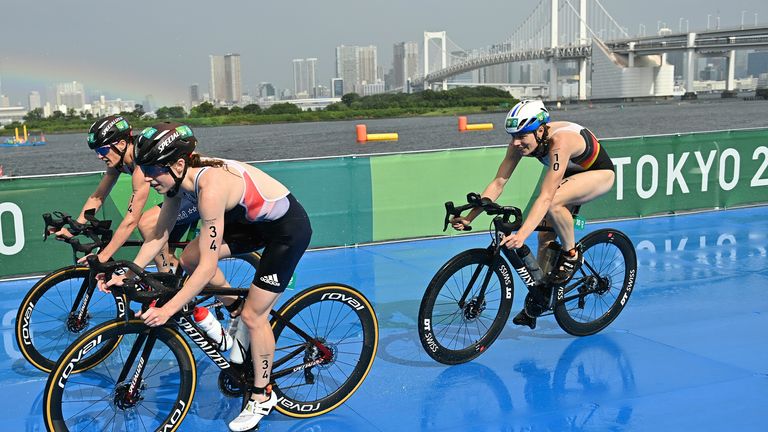 Duffy (Bermuda), Zafares (USA), and Taylor-Brown (Great Britain) cycle in front of the Rainbow Bridge in Tokyo