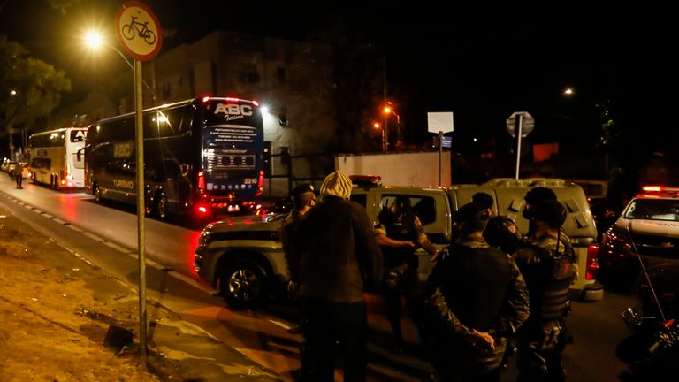 A bus carrying Argentina's Boca Juniors soccer team sits parked outside a police station in Belo Horizonte