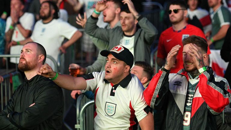 England supporters watch as Harry Kane takes a penalty and scores their second goal against Denmark
