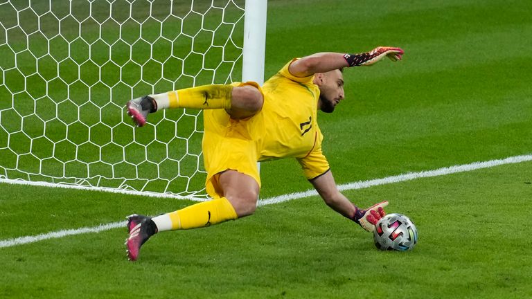 Italy's goalkeeper Gianluigi Donnarumma saves a penalty by Spain's Alvaro Morata during the Euro 2020 soccer championship semifinal between Italy and Spain at Wembley 