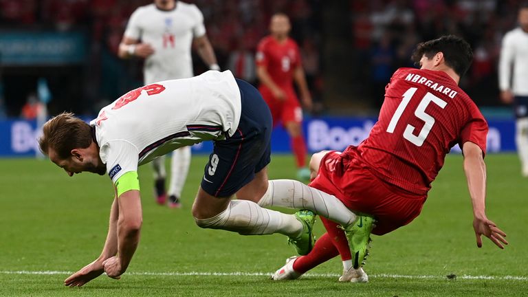 Harry Kane is challenged by Denmark's Christian Norgaard