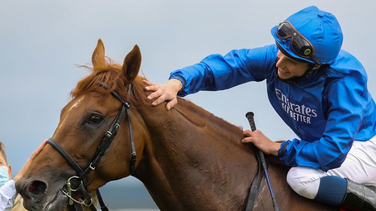 Hurricane Lane gets a well-earned pat down the neck from Buick after winning the Irish Derby