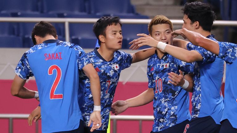 Japan&#39;s Takefusa Kubo (2nd from L) is congratulated by his teammates after opening the scoring