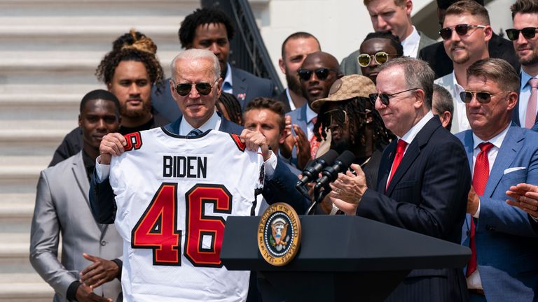 President Joe Biden, holds a Tampa Bay Buccaneers jersey presented to him by the team during a ceremony on the South Lawn of the White House, in Washington, Tuesday, July 20, 2021, where the president honored the Super Bowl Champion Tampa Bay Buccaneers for their Super Bowl LV victory. (AP Photo/Manuel Balce Ceneta)                                                   