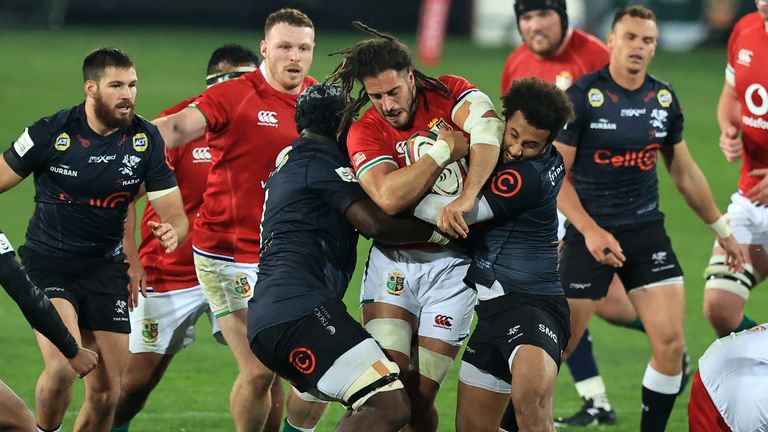 Josh Navidi of The British and Irish Lions is tackled by James Venter and Jaden Hendrikse