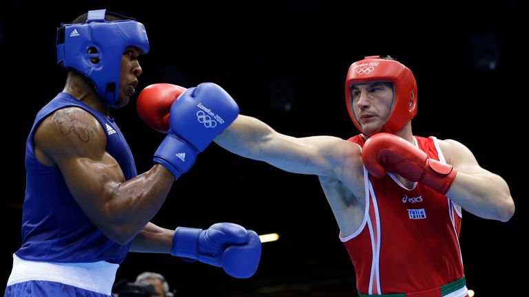 Italy's Roberto Cammarelle RED fights Britain's Anthony Joshua BLUE in a super heavyweight over 91-kg gold medal boxing match at the 2012 Summer Olympics, Sunday, Aug. 12, 2012, in London. (AP Photo/Patrick Semansky)