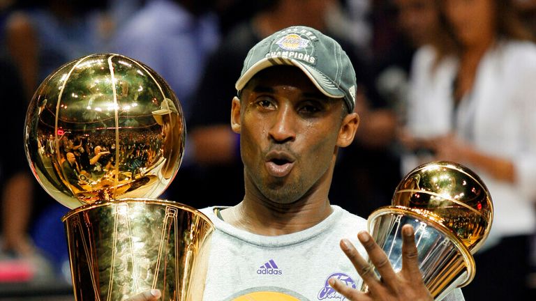 Los Angeles Lakers' Kobe Bryant holds the Larry O'Brien championship trophy and finals MVP trophy after the Lakers beat the Orlando Magic 99-86